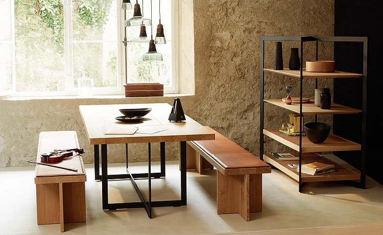 Mélange de matériaux harmonieux : pieds en métal de la table avec surface de dépose en bois massif, et beau revêtement en cuir pour le banc en bois